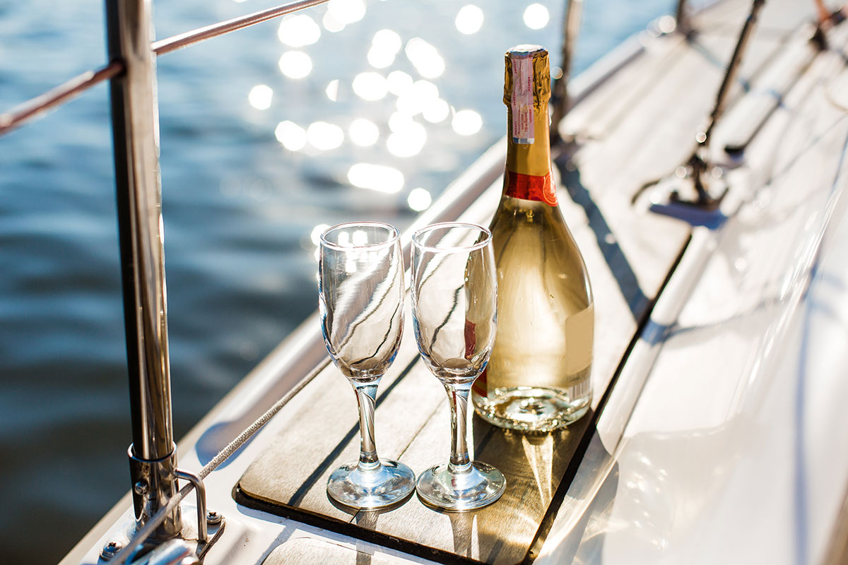 two champagne glasses and wine on luxury yacht