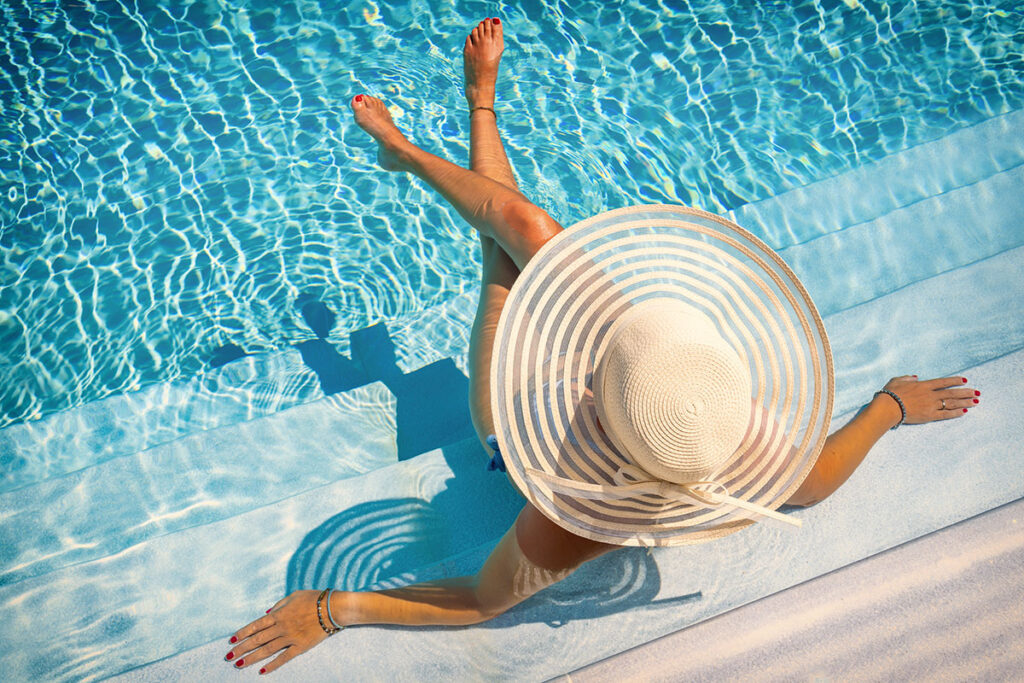 woman lounging in pool luxury resort