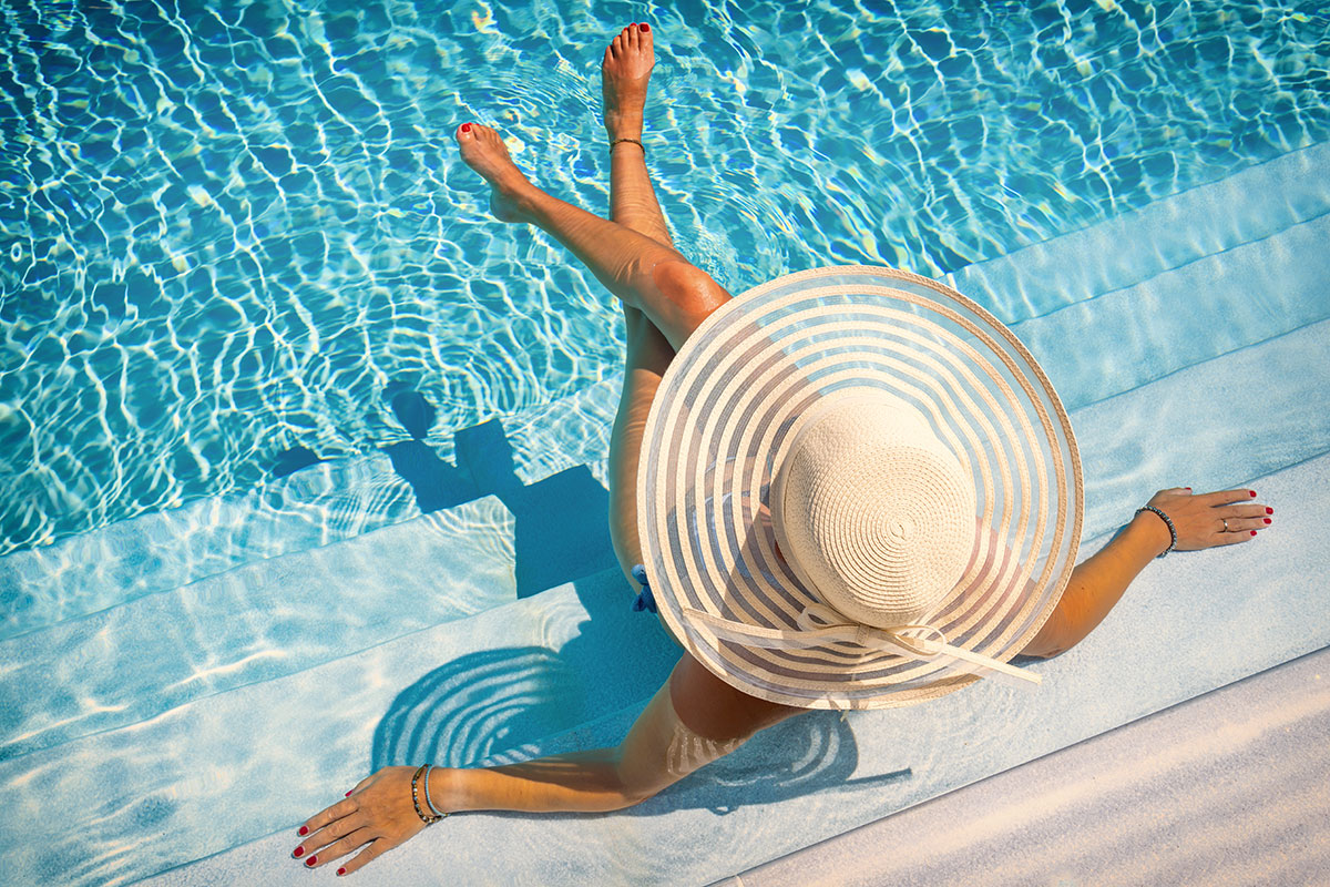woman lounging in pool luxury resort